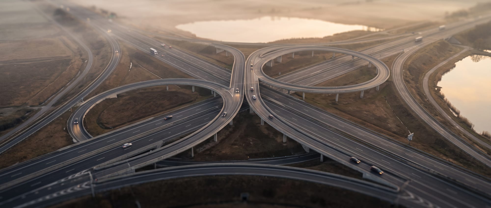 Aerial view of a tangled motorway junction in morning mist
